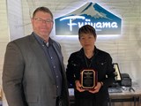 Pretreatment Manager with Fujiyama Manager holding their Food Establishment Excellence Award inside the restaurant 