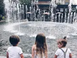 Three children sitting with their back to the camera at the Village at Meridian water display